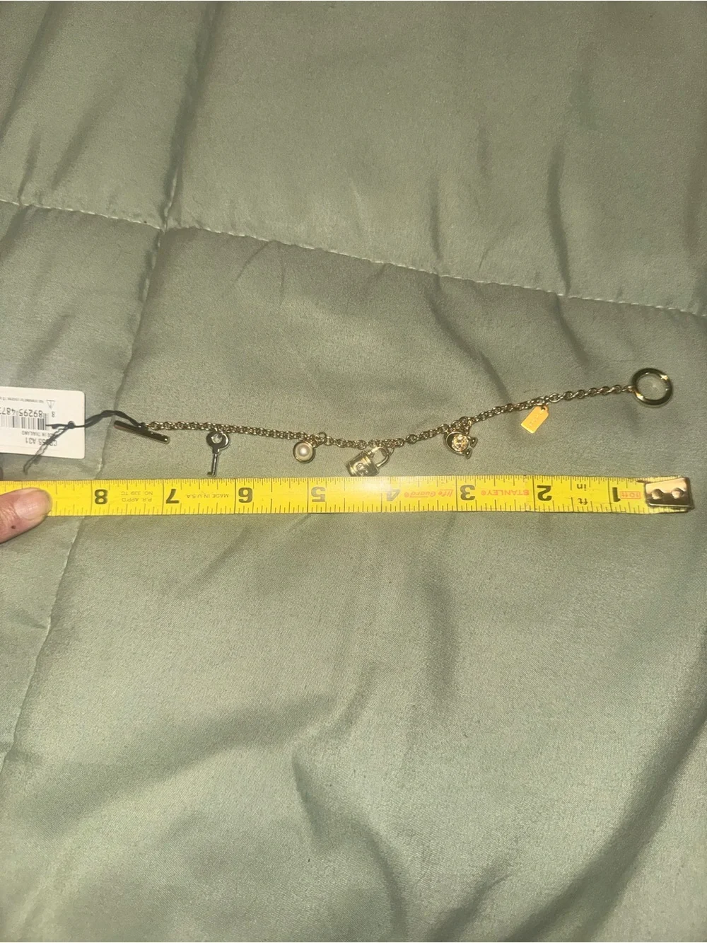 Coach Gold tone Charm Bracelet with Padlock, Key and Pearl Accents CD855 A31